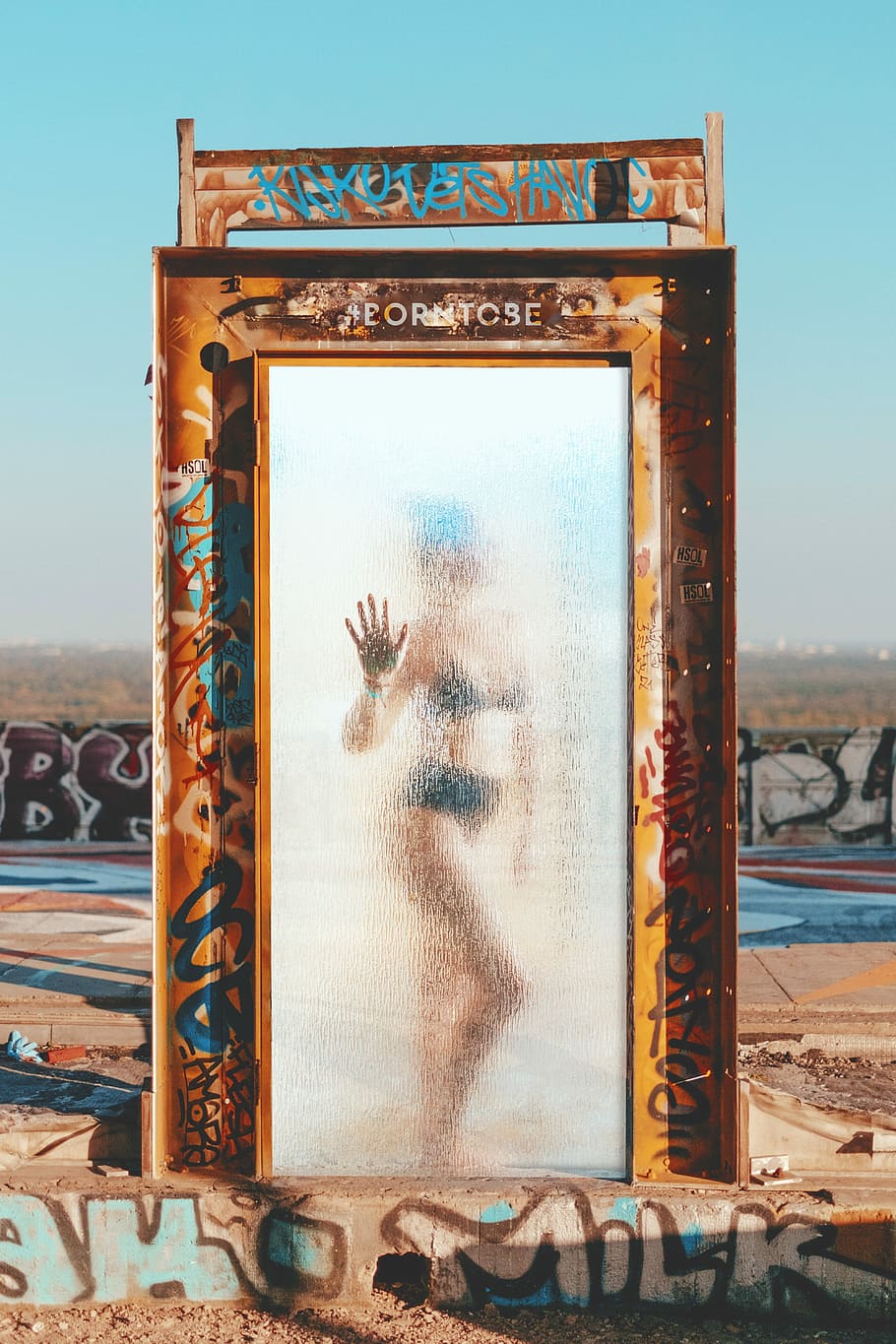 person inside the brown steel frame, brown steel door frame with glass panel HD wallpaper