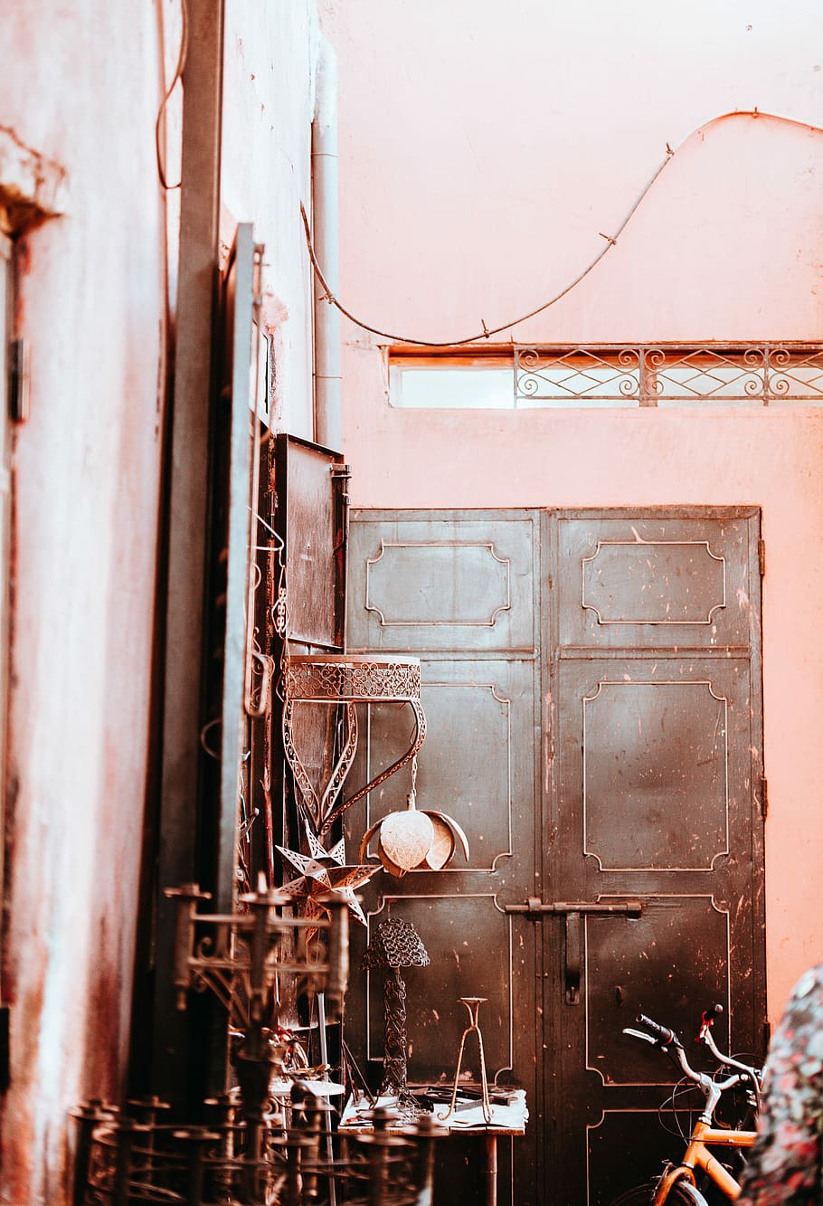 In the Souks, Marrakesh, room with brown metal gate, wall, pink