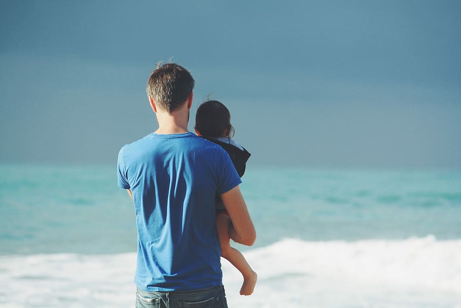 man in blue shirt carrying baby beside seashore, men, beach, adult HD wallpaper