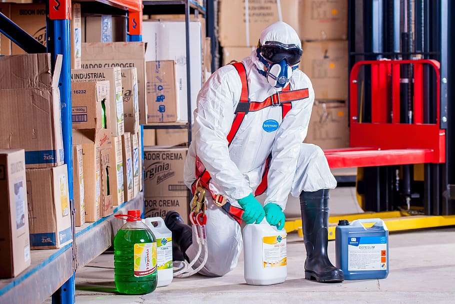 man wearing coveralls holding white bottle, chemist, costume HD wallpaper