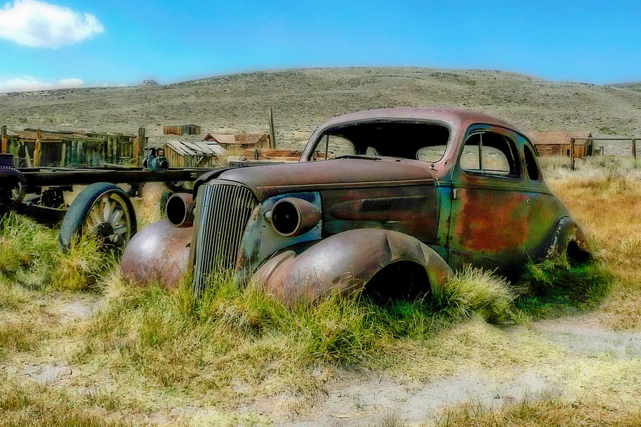 rusty Beetle car parked in middle of grass field, bodie, ghost town