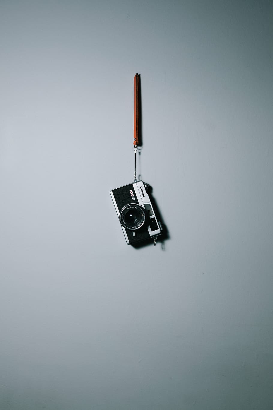 black and grey SLR camera hanging on wall, white, surface, canon HD wallpaper