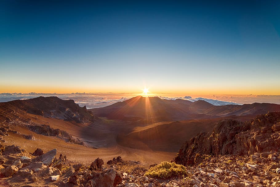 brown mountains during sunrise, stone formation in a distance of a desert during sunset HD wallpaper
