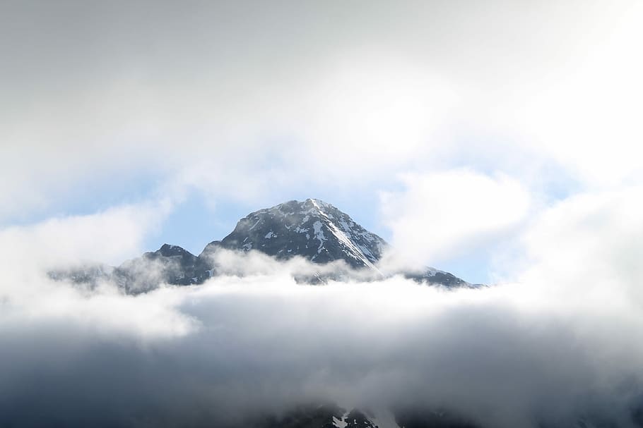 black mountain covered with white clouds, snow-covered mountain surrounded by clouds during daytime HD wallpaper