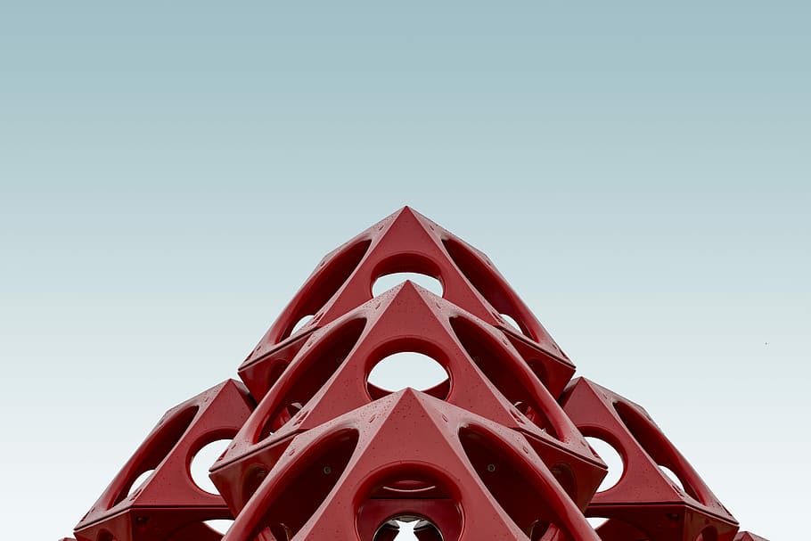 red geometrical structure, low-angle photography of red building under grey sky HD wallpaper