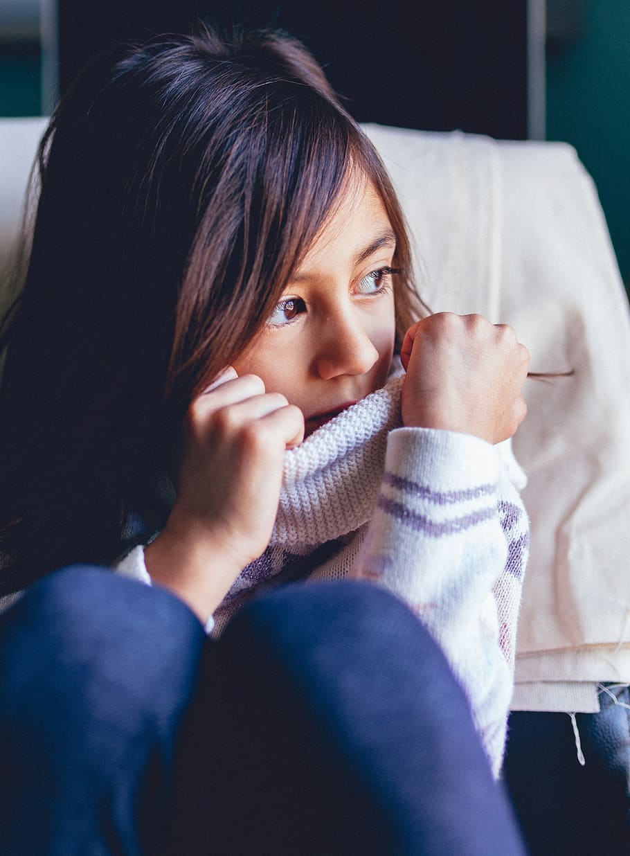 girl sitting on vehicle seat while looking at window, photography of girl in white sweater and blue pants HD wallpaper