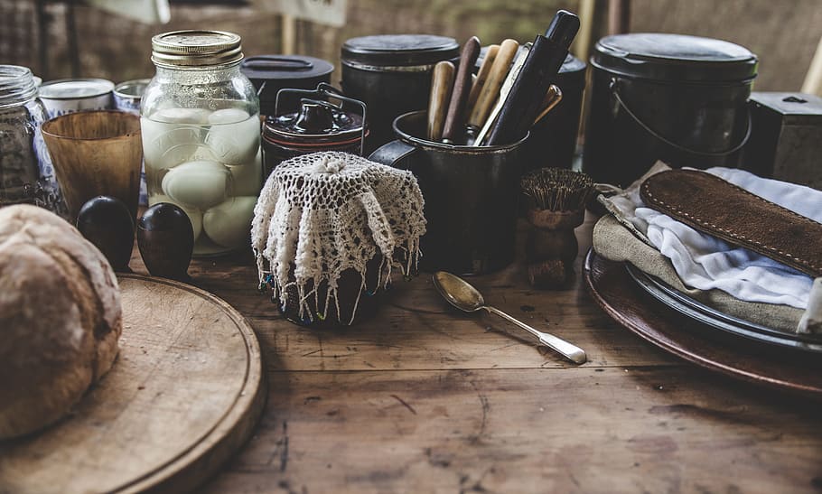 assorted kitchen tools on brown wooden panel, bottles, bread HD wallpaper