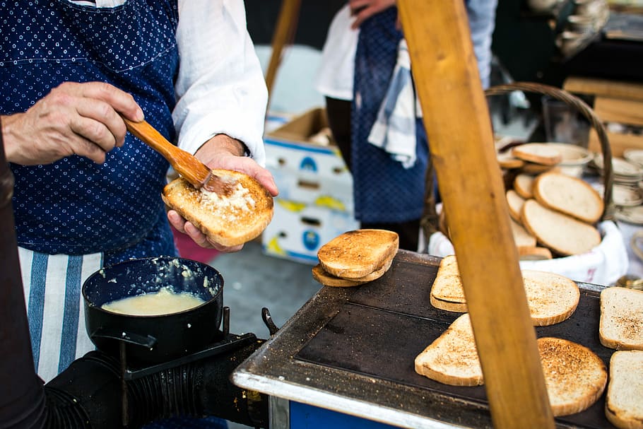 Traditional Czech toasted bread with garlic, hands, market, outside HD wallpaper