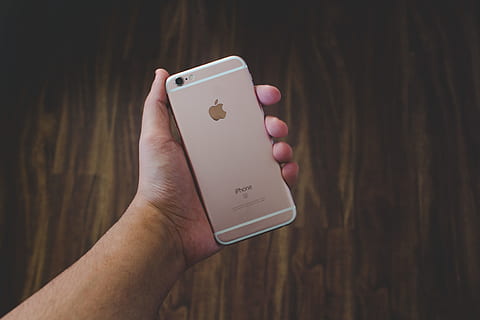 Person holding an iPhone mobile smartphone in their hand, technology HD wallpaper
