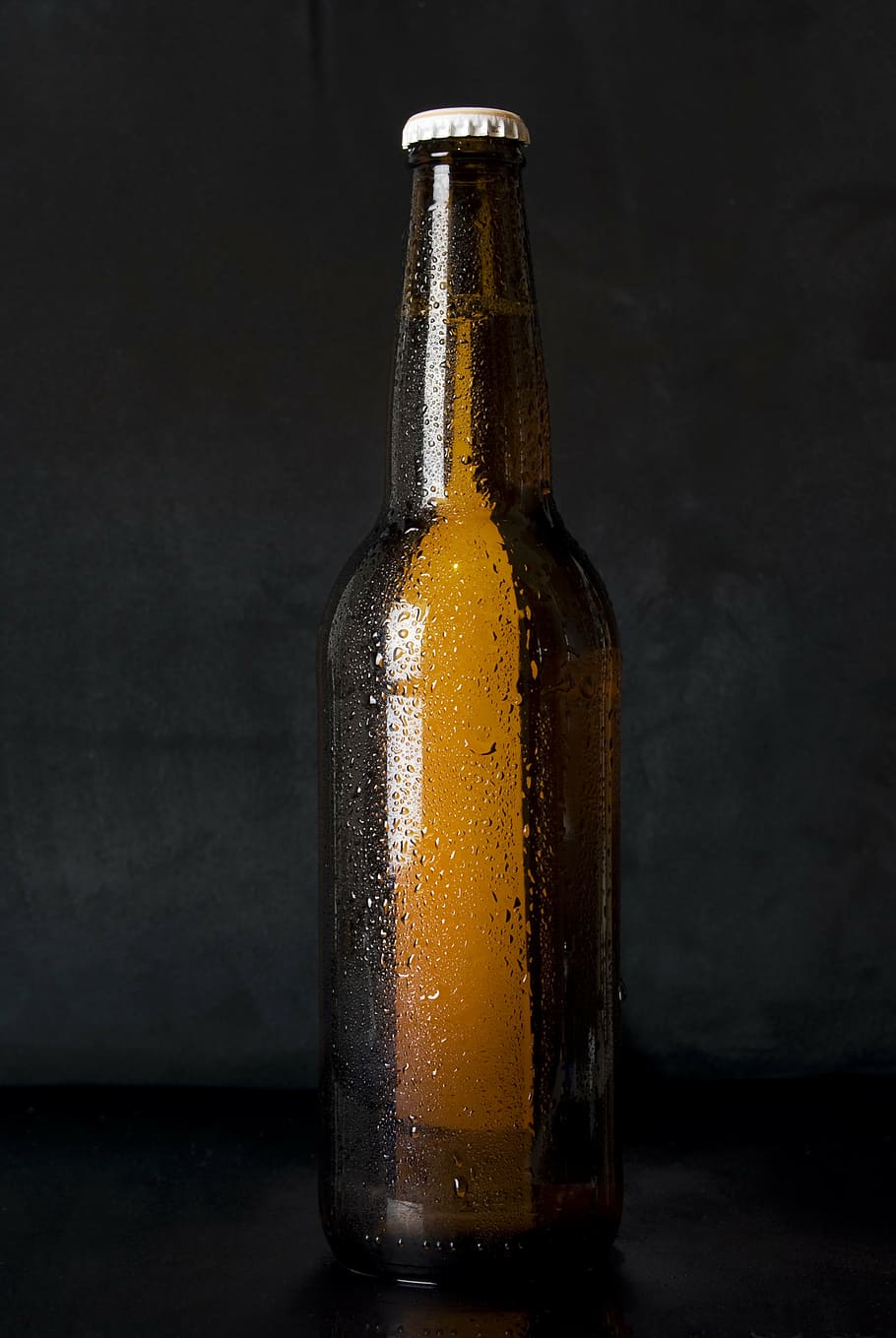 brown glass bottle on top of black surface, beer, alcohol, brew