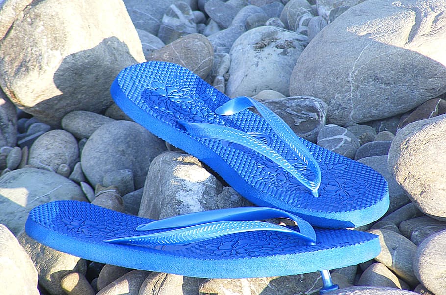 pair of blue flip-flops beside rocks, sandals, flip flops, sea