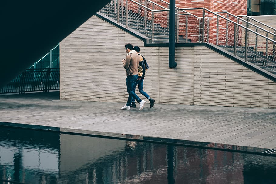 men walking on side of road, two, holding, phones, architecture HD wallpaper