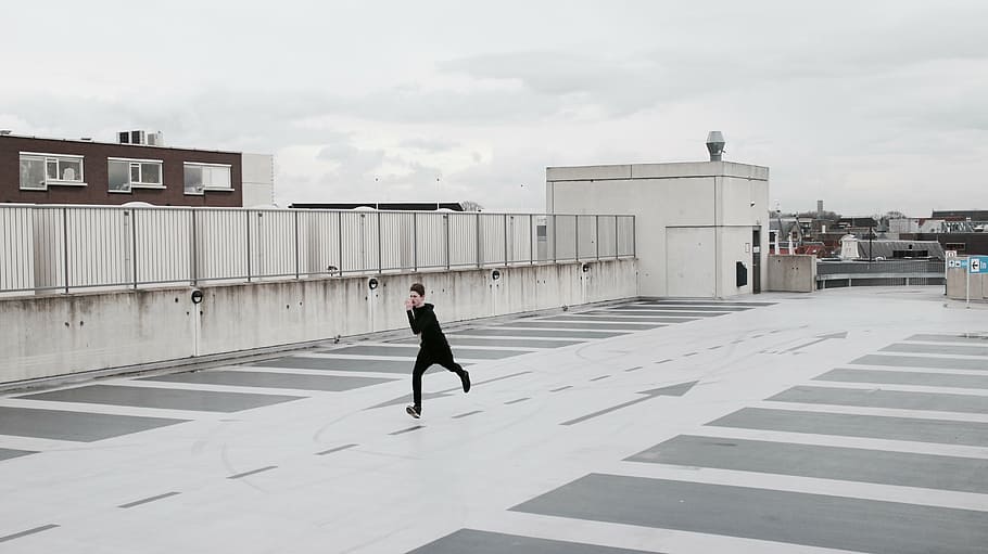man running on rooftop, architecture, building, structure, sky HD wallpaper