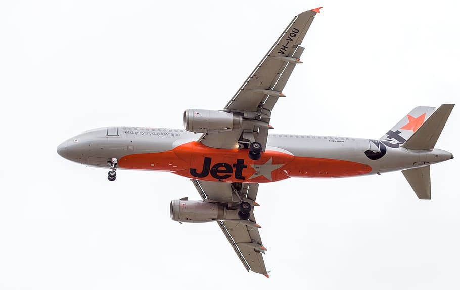 gray and orange plane, passenger jet, jetstar, townsville airport