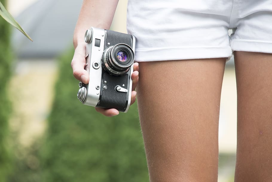 person holding mirrorless camera, girl, retro, holds, travel HD wallpaper