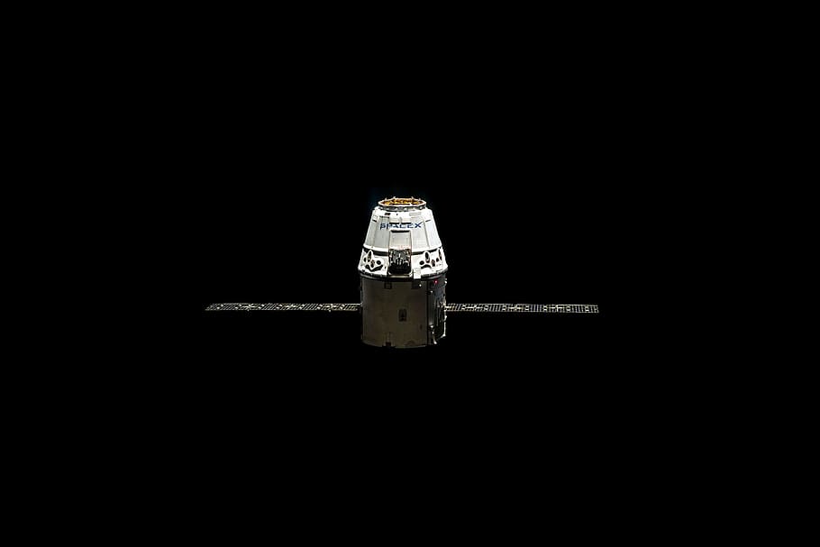 white and black satellite pod with two solar arrays, orbit, spacex