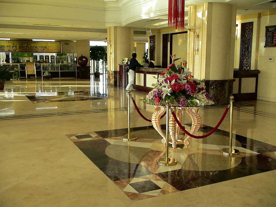 assorted flowers bouquet centerpiece on clear glass coffee table beside stanchions near person beside counter desk HD wallpaper
