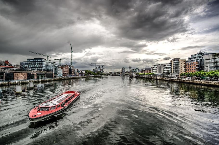 red and white passenger boat on body of water, Liffey, River