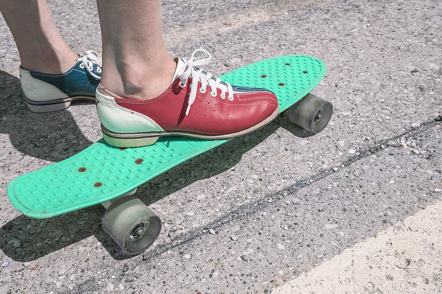 person riding green penny board, objects, lazy, skateboard, shoes
