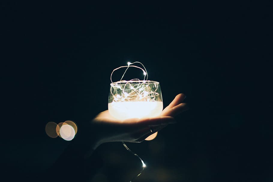 person holding glass with light, lights, night, dark, hand HD wallpaper