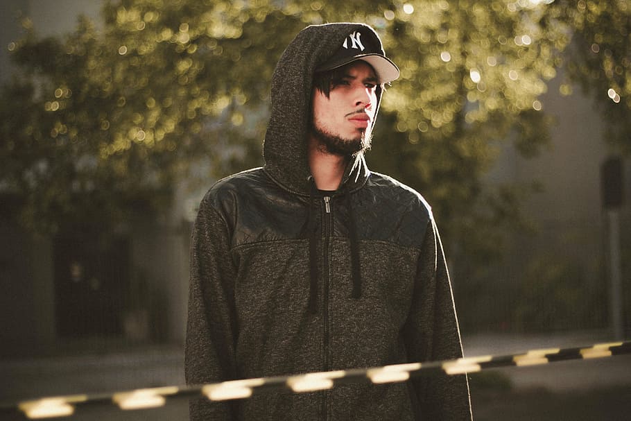 man wearing black zip-up hoodie standing near tree, gray, people,man HD wallpaper