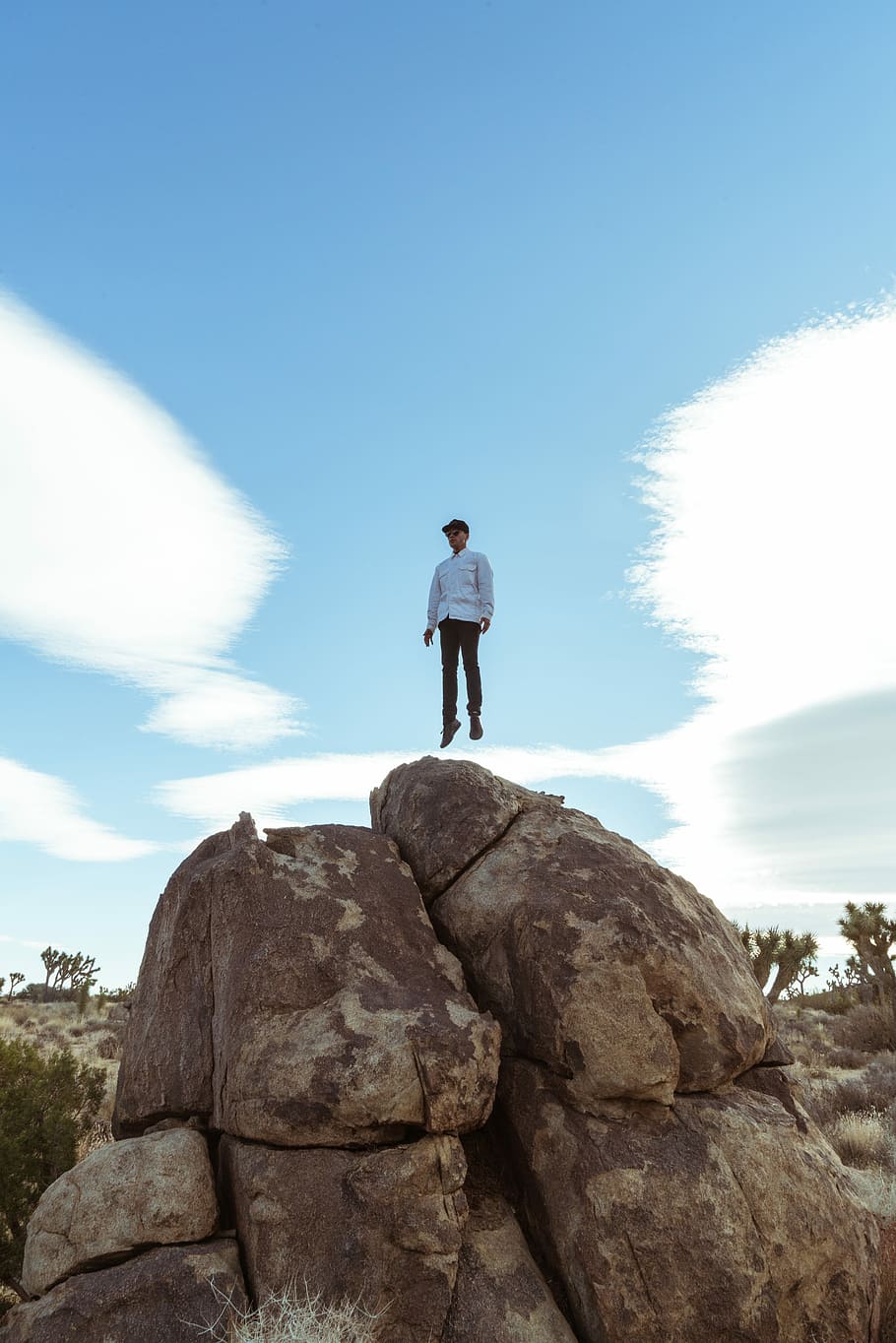 man jump on brown boulder, man jumping on rock, blue, sky, cloud HD wallpaper