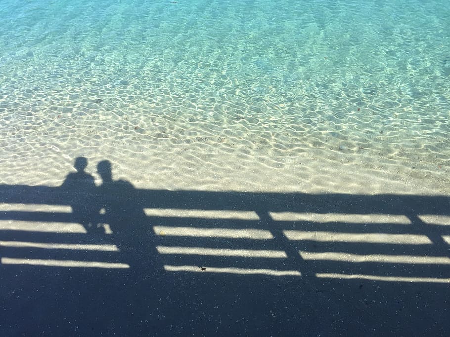 shadow of boy and man near fence, shadow of two person on the ocean HD wallpaper