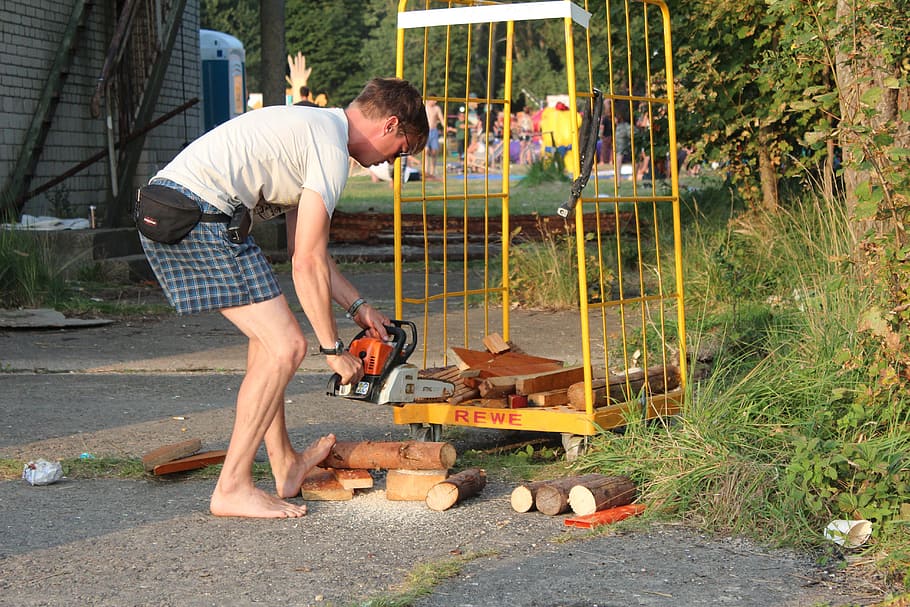 man cuts some wood using chainsaw, security, saw off, tribe HD wallpaper