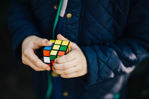 Boy in a blue jacket holding things, man, ball, rubik's cube HD wallpaper