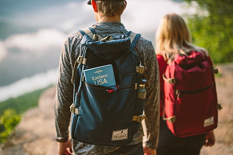 two man and woman carrying backpacks, blue book inside man's blue backpack HD wallpaper