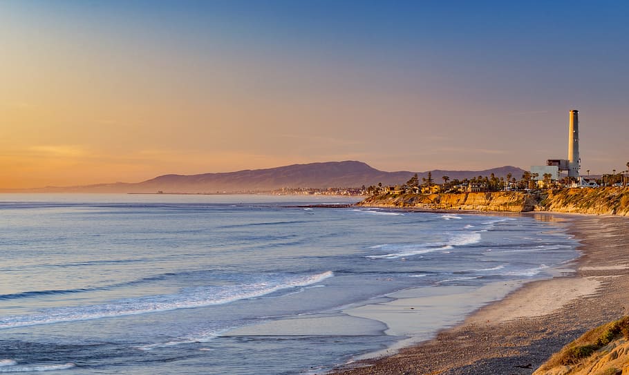 body of water with waves during daytime, landscape photography of tower near body of water HD wallpaper