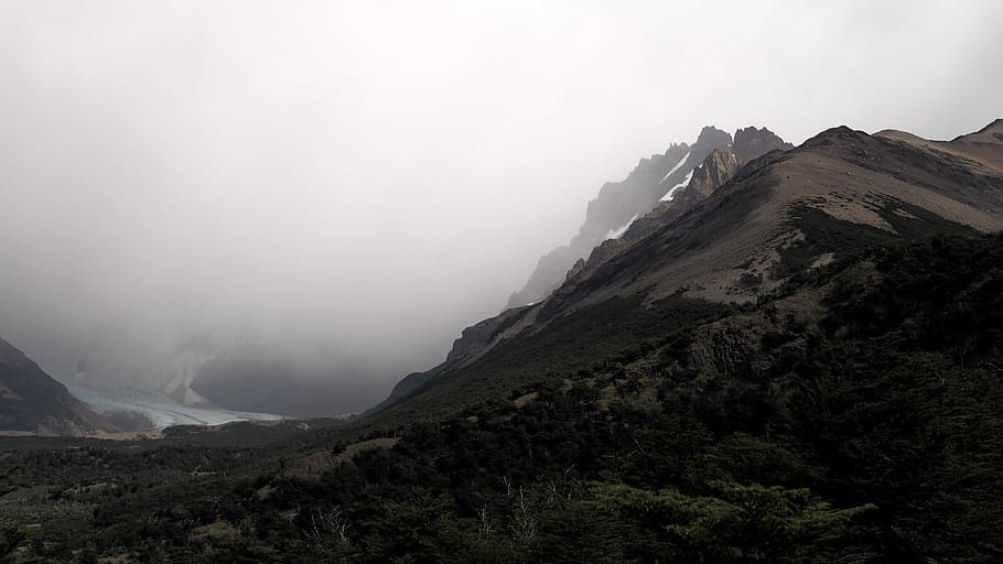 brown mountain photo at daytime, landscape of mountain covered with fog HD wallpaper