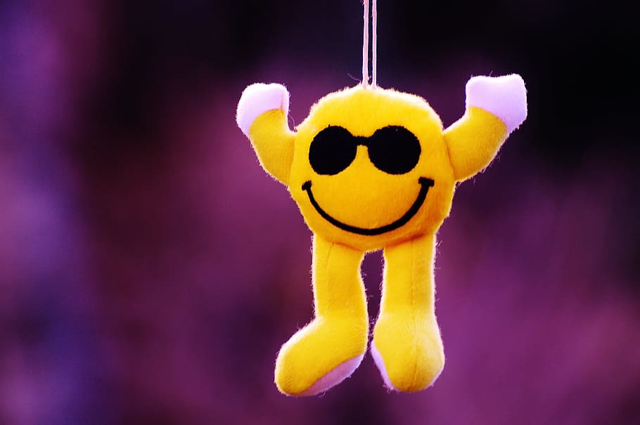 selective focus photography of hanging yellow emoji plush toy HD wallpaper