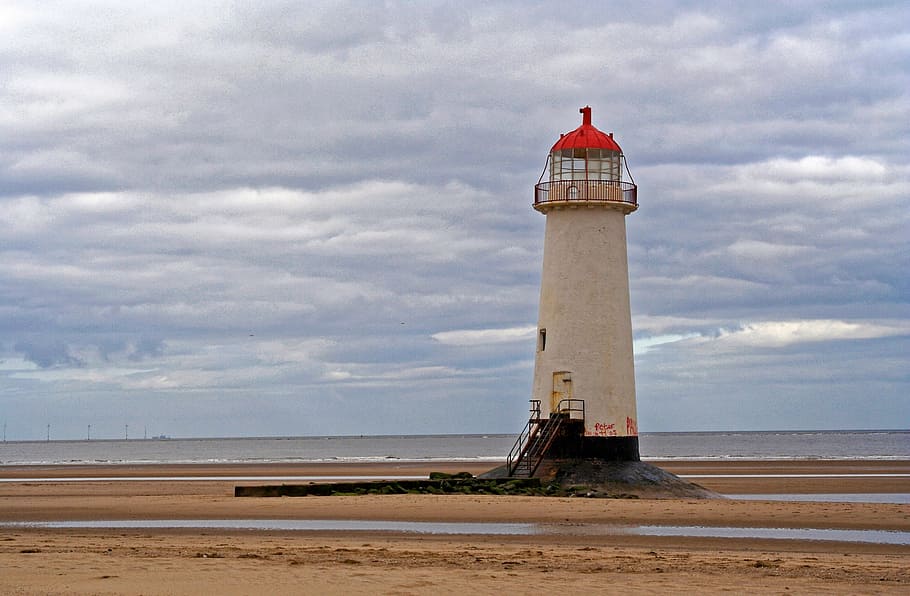 white lighthouse near body of water under cloudy sky, beach HD wallpaper