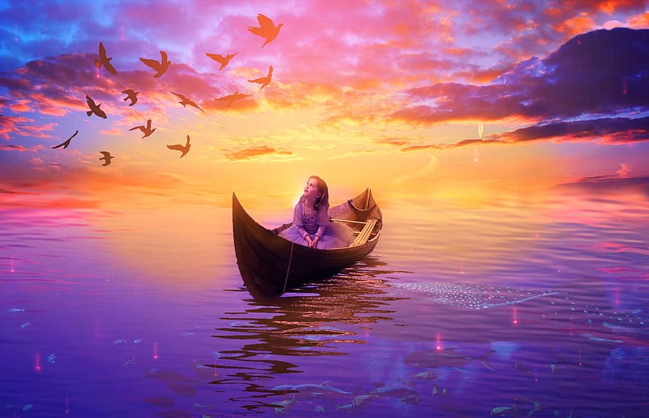 girl in boat on body of water looking at flock of birds flying in the sky during sunset