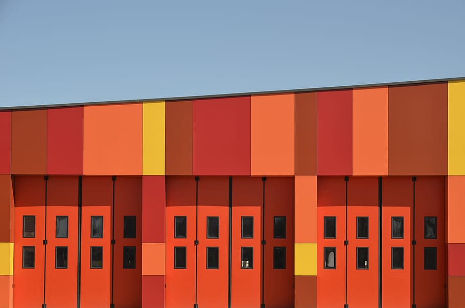 orange building, architectural photography of red wooden doors HD wallpaper