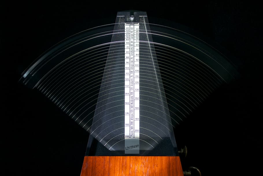 closeup photo of gray and brown measuring tool, metronomes, tempo