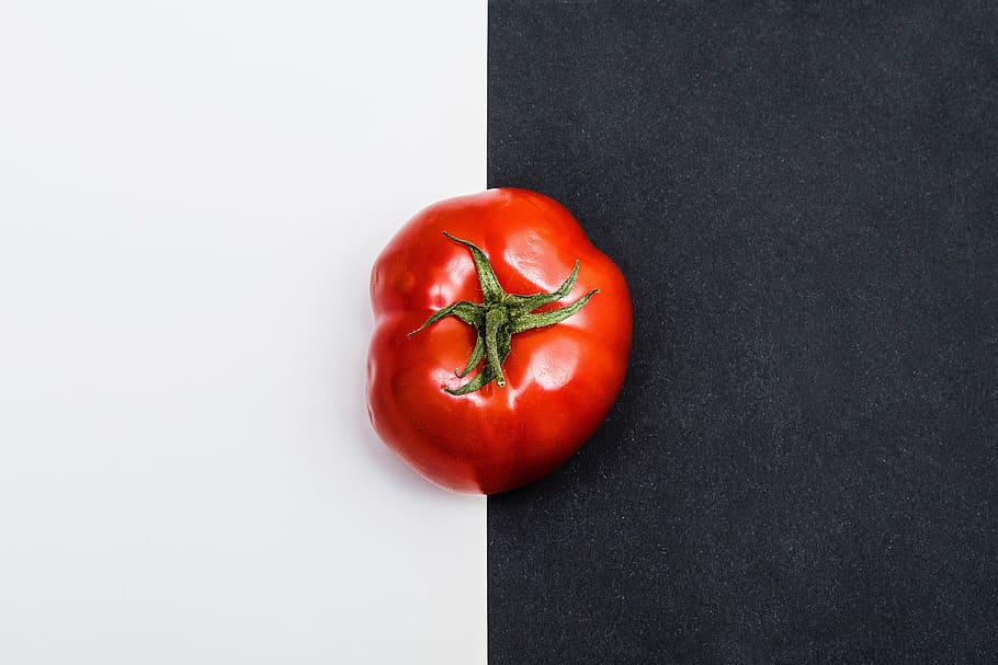 red heirloon tomato on white and black surface, fruit, vegetable HD wallpaper