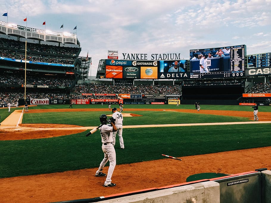 baseball players playing on field during daytime, New York Yankees baseball game in statdium