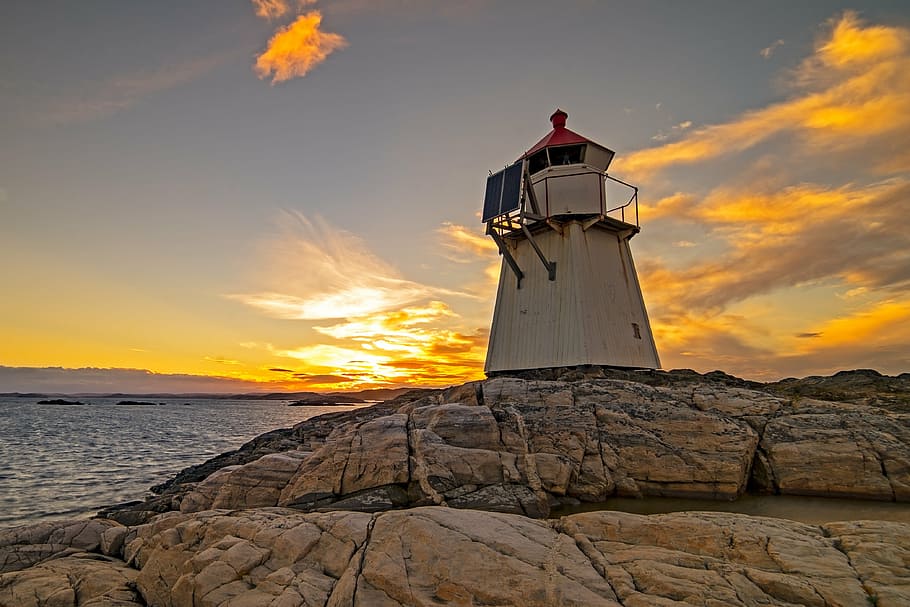 lighthouse near body of water, ocean, sunset, coast, marine HD wallpaper