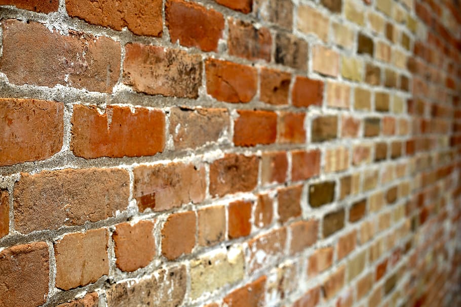 brown brick wall in selective focus photography, wall of bricks