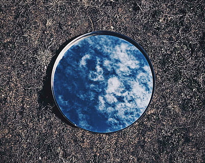 round mirror reflecting blue sky on ground, clouds, reflection HD wallpaper