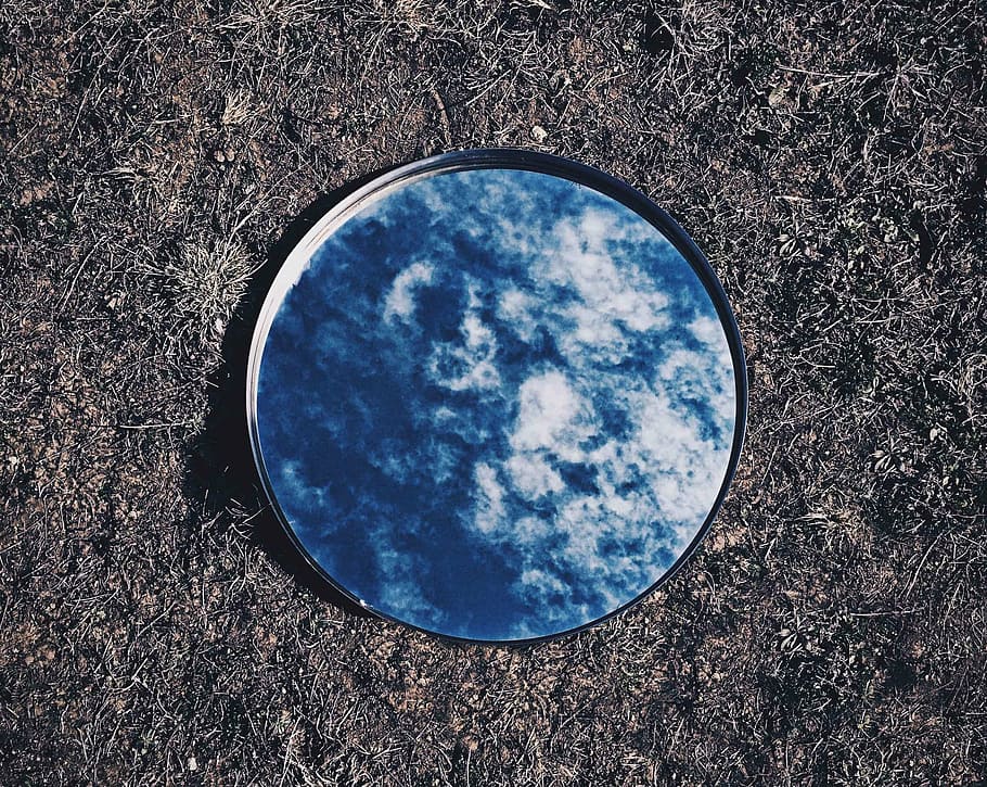 round mirror reflecting blue sky on ground, clouds, reflection HD wallpaper