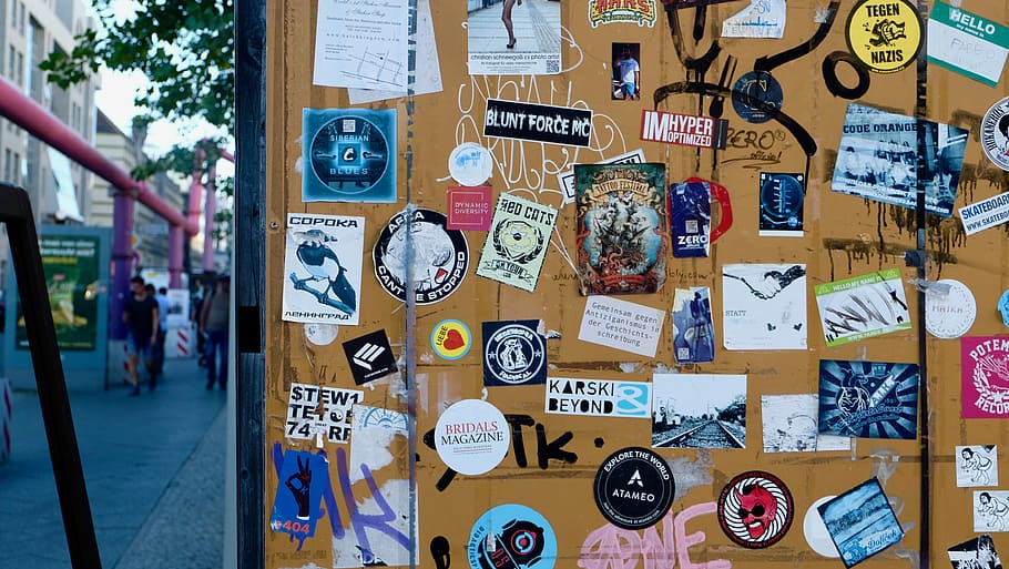 Lot’s of stickers on a yellow wall, assorted sticker on brown steel surface HD wallpaper