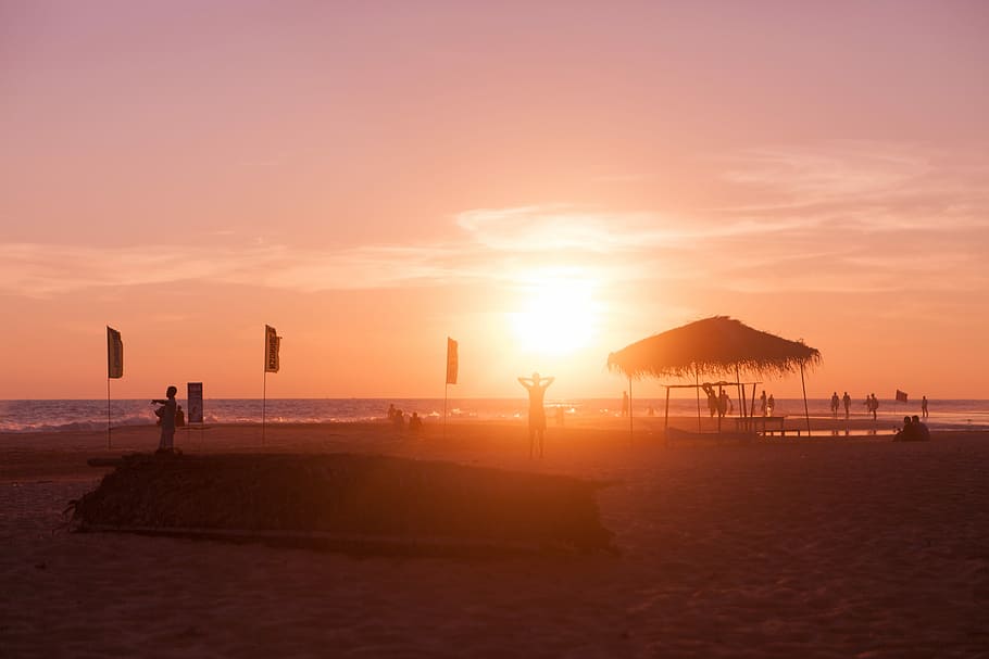 silhouette beach hut near seashore during sunset, panoramic photography of brown sand beach under golden hour HD wallpaper