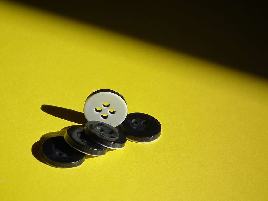 close-up photo of black and white buttons on yellow suface HD wallpaper