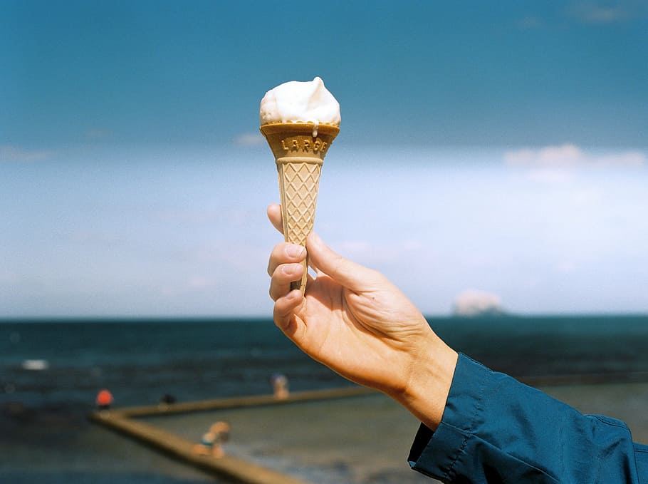 beach, cone, hand, holding, leisure, outdoors, sea, seashore HD wallpaper