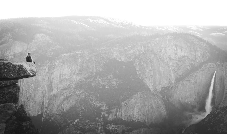 Isolation, grayscale photo of person sitting on cliff, mountain HD wallpaper