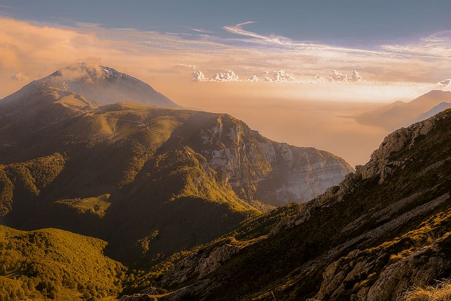 mountains at golden hour, bird's eye view of valley under cumulus clouds HD wallpaper
