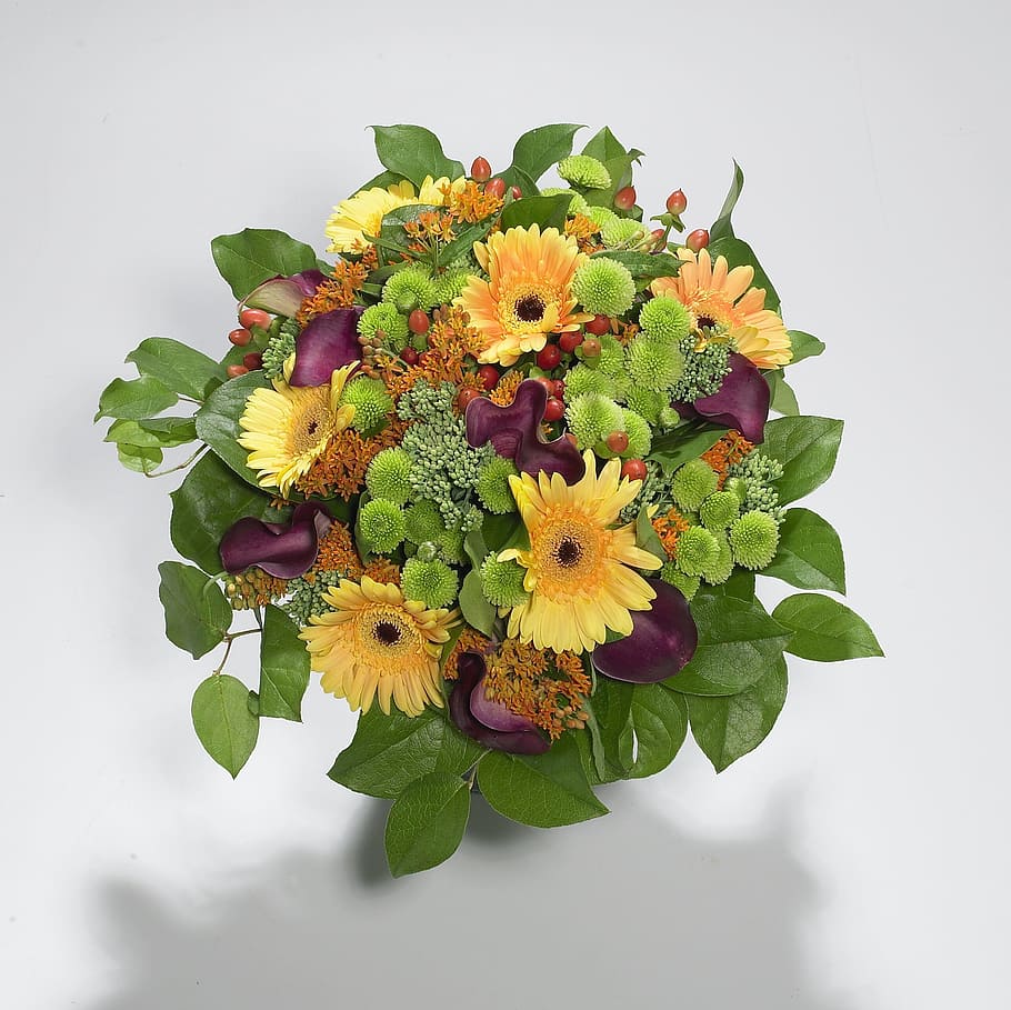 purple, yellow, and green daisies, mums and calla lilies bouquet.